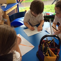 Children writing at desk